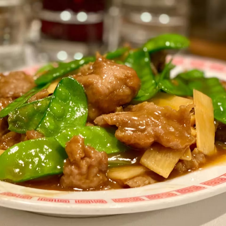 Lai Lai Restaurant's beef with snow peas and bamboo shoots, glistening in a savory sauce.