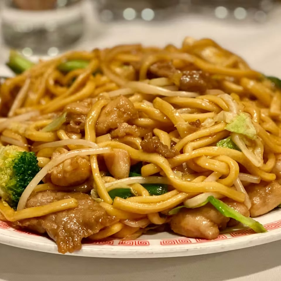 Lai Lai Restaurant's chicken chow mein with noodles, broccoli, bean sprouts, and green onions.